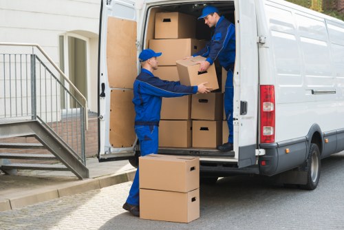 Small removals team transporting furniture for a flat move in Oldford