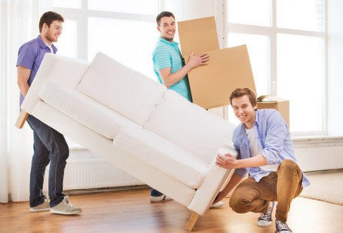 Expert packers handling fragile items during an Oldford move